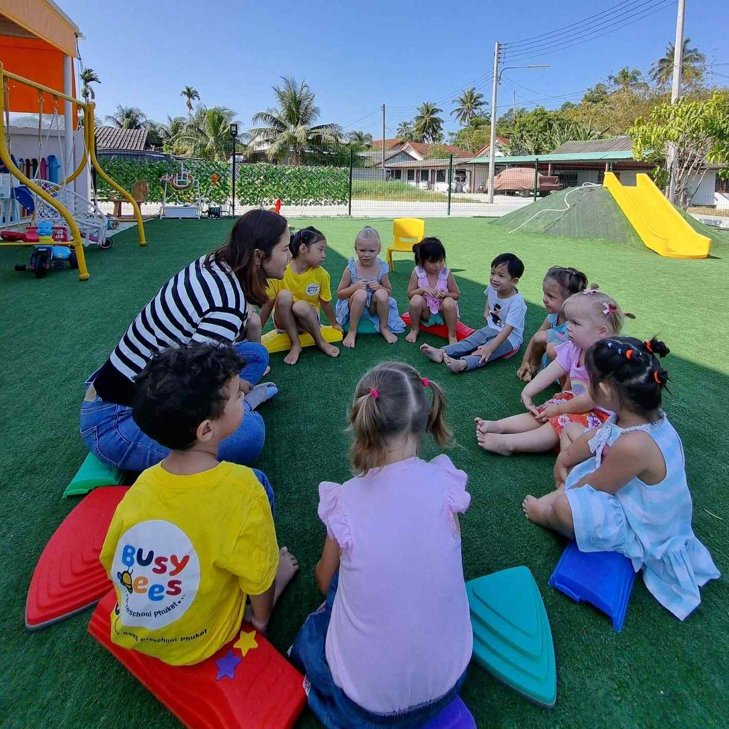 Caring teacher guiding children